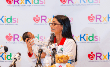 Dr. Mona holding a newborn baby